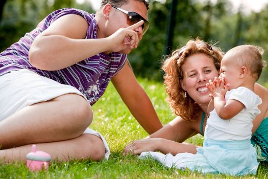 The family and a happy babys first day out in the park