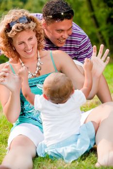 The family and a happy babys first day out in the park