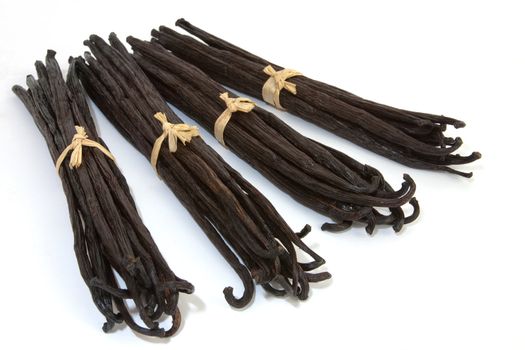 Four boots of Bourbon vanilla beans isolated on white background