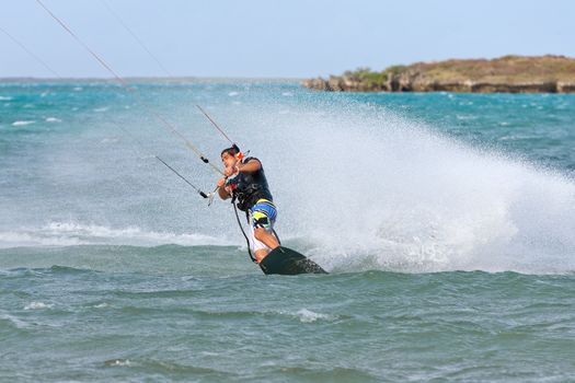 Male kitesurfer enjoying his sport in the lagoon of Babaomby, Madagascar