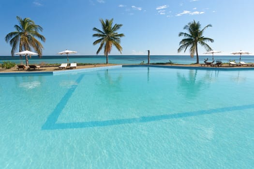 Swimming pool facing the lagoon in a tropical hotel