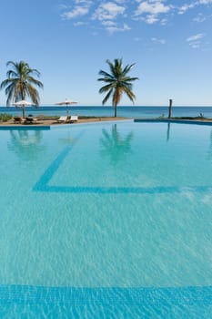 Swimming pool facing the lagoon in a tropical hotel