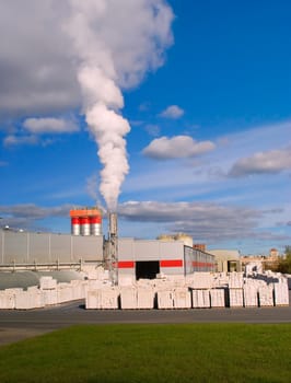 Factory with a chimney and white smoke