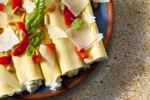 Cannelloni pasta stuffed with ricotta cheese, shot from directly above.