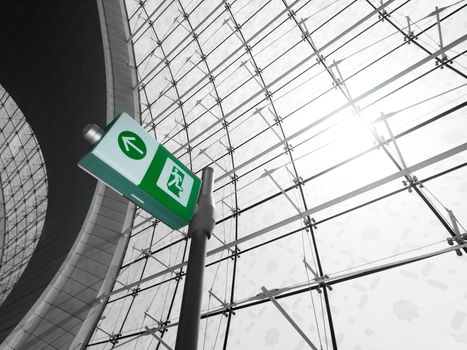 Green exit sign inside  a modern airport with sun