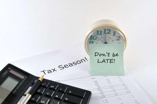 Tax Season. Don`t be late. Concept Image with calculator and clock