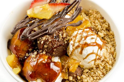 ice cream with chocolate, nuts and caramel close up