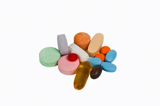 Different colorful pills with capsules on the white background.
