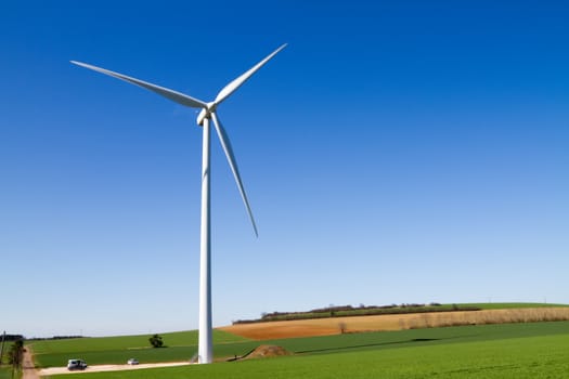 A wind turbine under clear blue sky