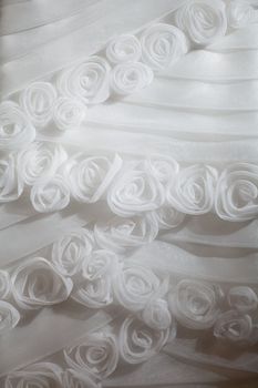 part of the white wedding dress with artificial flowers