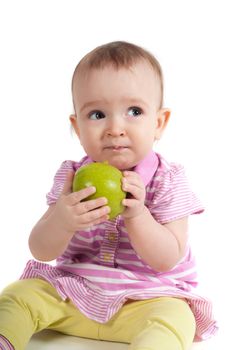 Shot of baby girl on pink eating apple