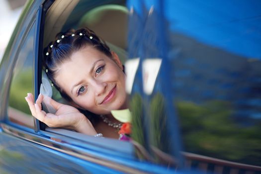 portrait of the bride in the car