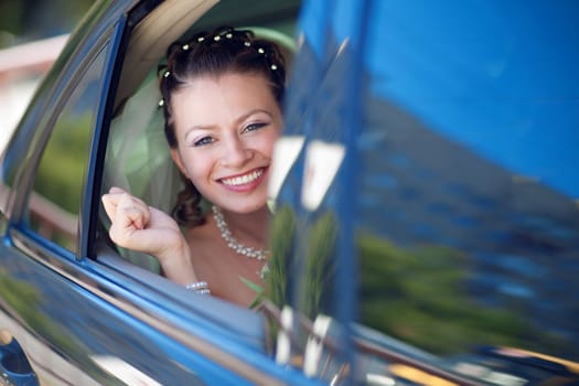 portrait of the bride in the car