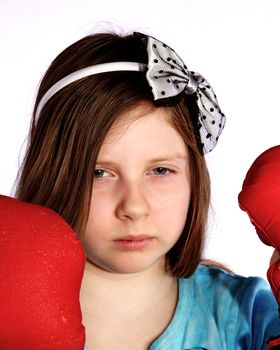 Young girl wearing boxing gloves and game face