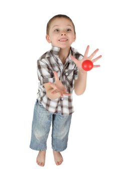 Young boy cathing a red ball on isolated background