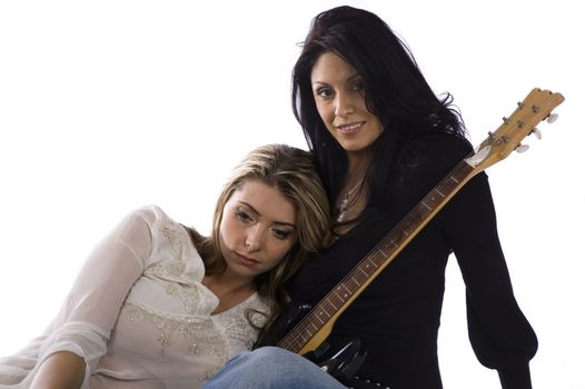 two female freinds sitting on the floor on a white background
