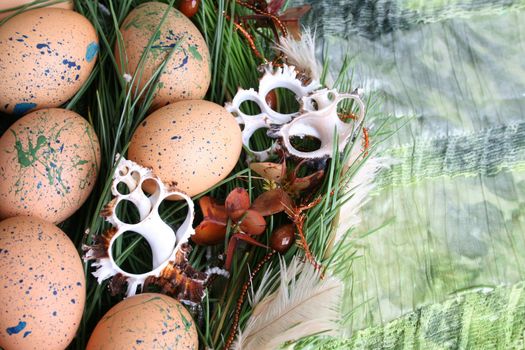 Easter wreath with eggs and decorations on green cloth