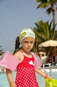 Portrait of a child playing by the pool