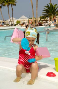 Child is playing by pool