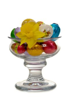 Easter eggs and flower in a big glass.