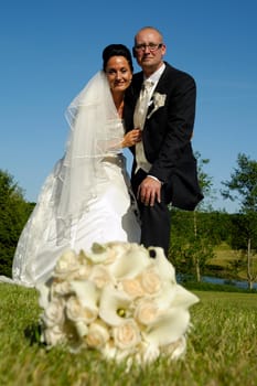 Wedding couple. The wedding couple are in blur and the focus are on flower bouquet.