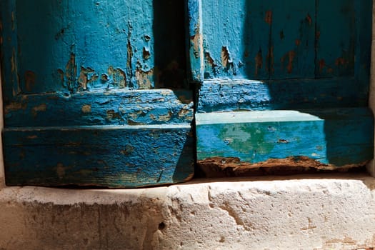 Blue wooden door with old peeling paint