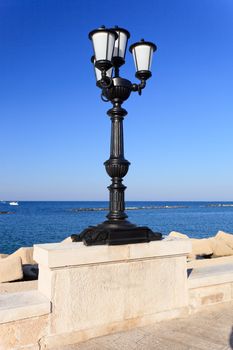 Black street light in Bari port Italy
