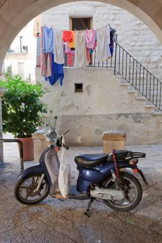 Retro blue scooter outside an Italian home