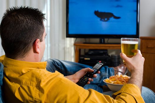 Guy enjoying his evening watching television from the sofa