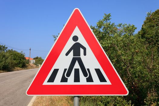 Man crossing road red triangle warning sign