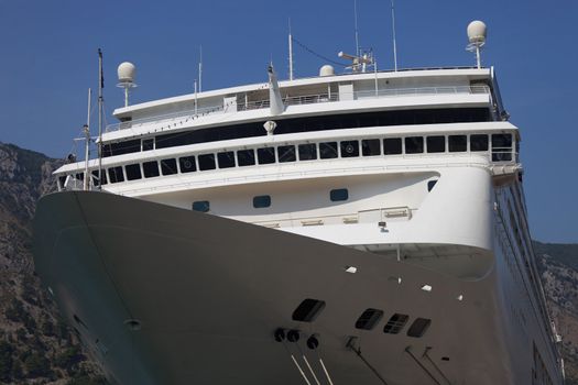 Modern white cruise ship bow at dock