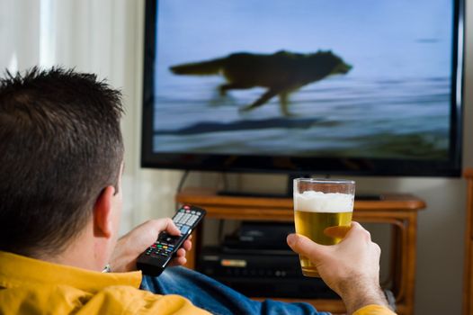 Guy enjoying his evening watching television from the sofa