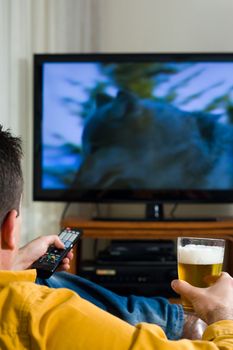 Guy enjoying his evening watching television from the sofa