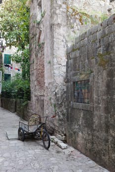 Abandoned delivery bike in old stone street