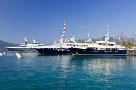 Three luxury yachts at dock in Montenegro