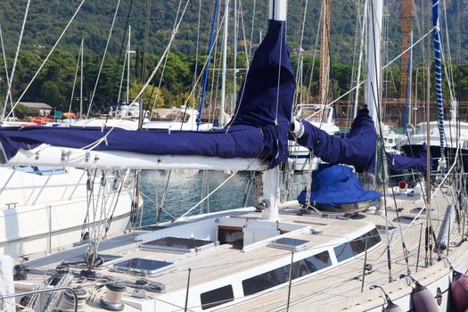 Teak deck and blue sails on a luxury yacht