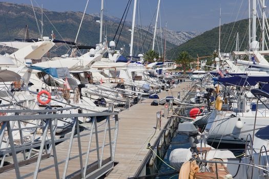 Boats at dock on a floating wooden jetty