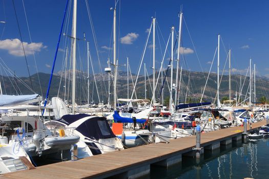 Luxury sailboats at dock against a floating wooden jetty