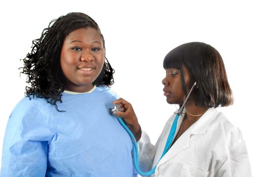 Young African American nurse or doctor checking African american woman's heart, isolated on white.