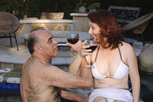 Middle-eastern Man and Hispanic woman enjoying laughter while in a hot tub