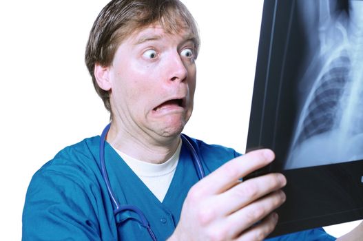 Male doctor looking with humorous shock at x ray