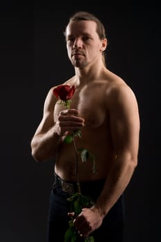 standing romantic man with red rose
