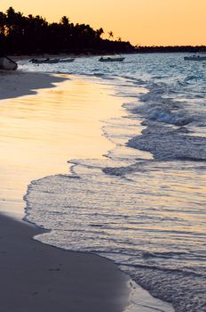 Sandy beach of a tropical resort at sunset