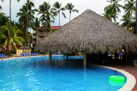 Swimming pool with swim up bar at tropical resort