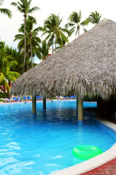 Swimming pool with swim up bar at tropical resort