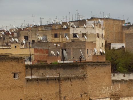 Satellite television dishes on the roofs of ancient buildings in Morocco