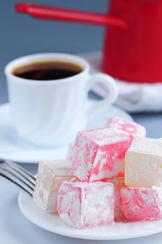 Turkish delight (lokum) confection with black coffee and traditional coffee pot
