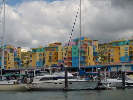 Yauchts and colourful resort condos along a bay in the Algarve region of Portugal