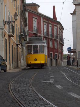 An historic yellow tram in Lisbon, Portugal.