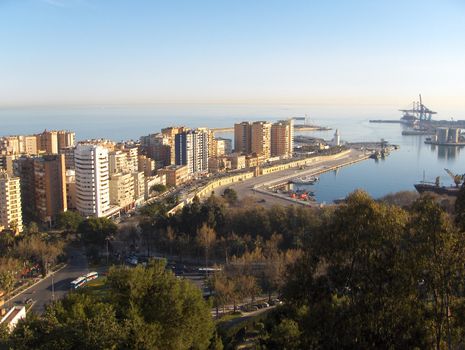 Looking down on the industrial harbour and resort high rises of Malaga, Spain.